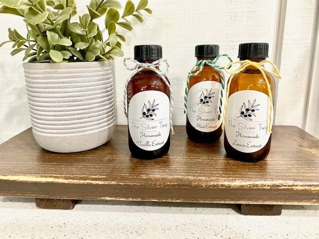 Homemade extract bottles on wooden shelf